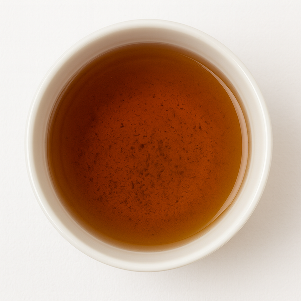 A white cup of freshly brewed Premium Hojicha seen from above
